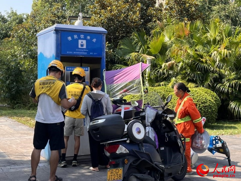 9月5日，正在“0011”號便民飲水點排隊接水的市民。周小平攝